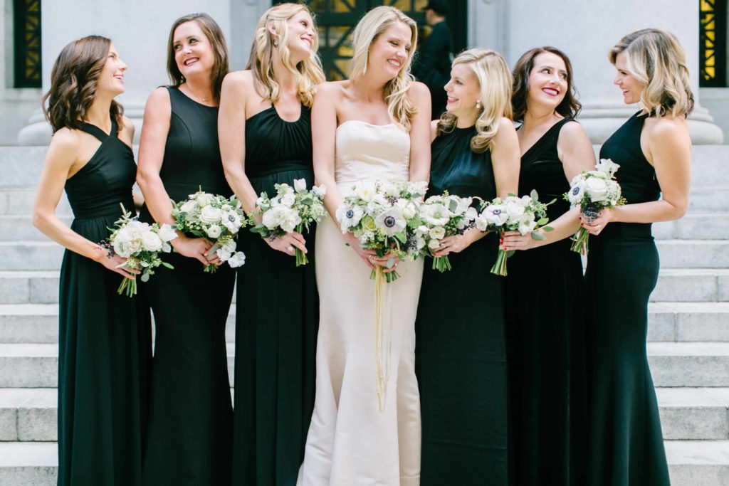 Bridal party in black gowns holding bouquets