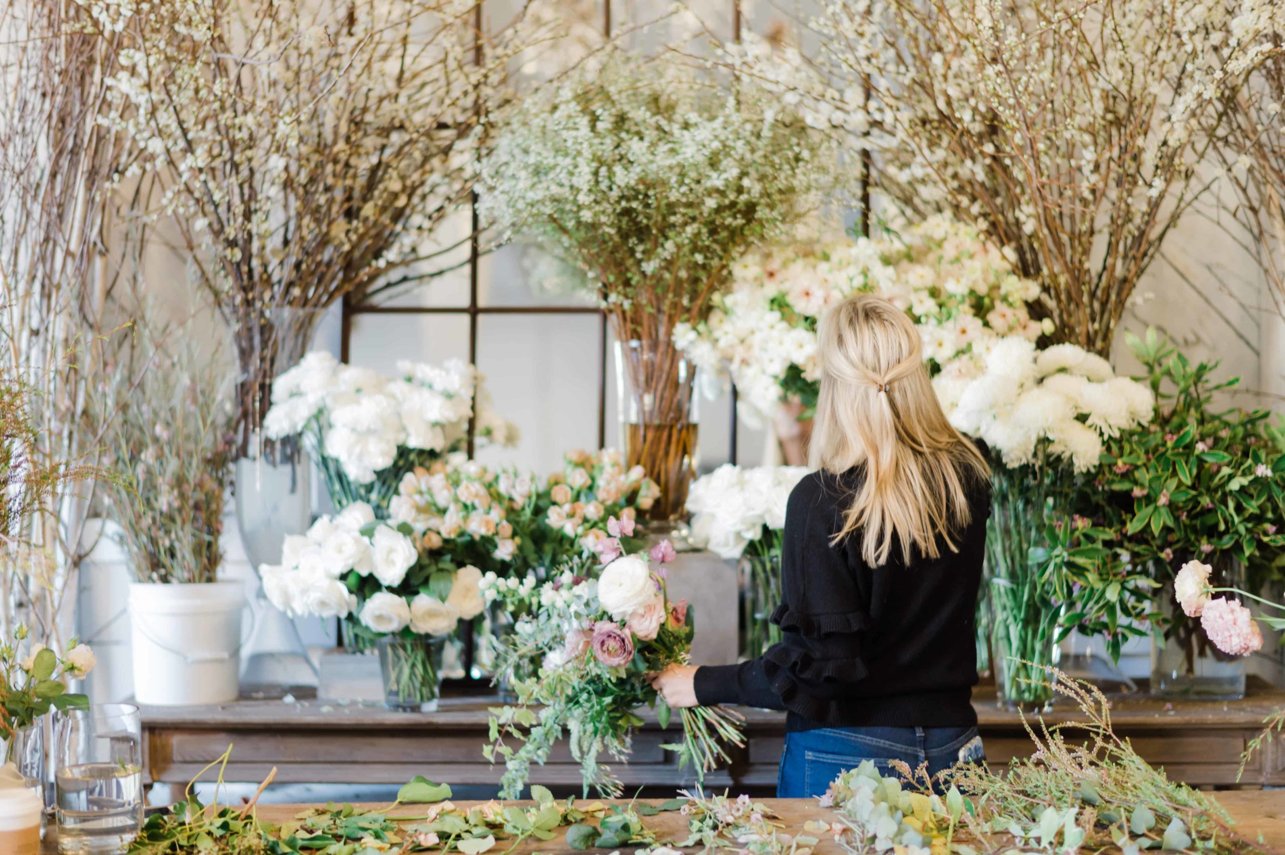 Wedding florist working with arrangements
