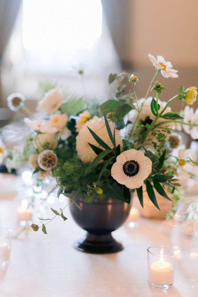 Green and white wedding flowers in a vase